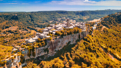 Panoramic aerial view of Civita di Bagnoregio from a flying drone around the medieval city, Italy.