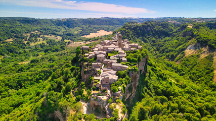 Panoramic aerial view of Civita di Bagnoregio from a flying drone around the medieval city, Italy.