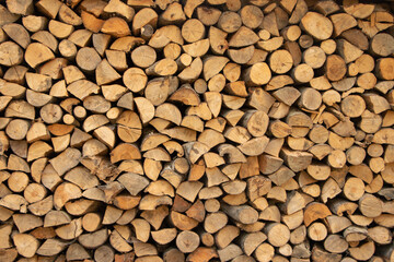 Wall firewood, Background of dry chopped firewood logs in a pile