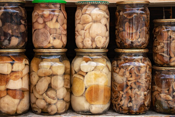 Glass jar of preserved many mushroom