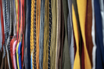 Lots of multicolored shoelaces displayed for sale on the street - obrazy, fototapety, plakaty