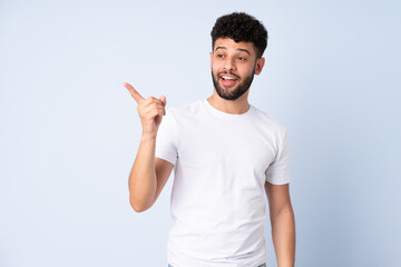 Young Moroccan man isolated on blue background intending to realizes the solution while lifting a finger up