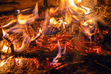 Bright flame of a burning fire in the dark