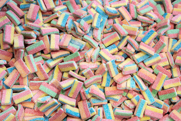 Multicolored jelly stick candies textured background