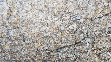stone texture or background. Coarse cracked stone structure of the face. empty gray stone texture or background