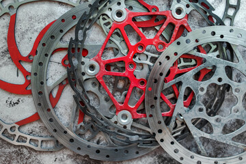 Worn mountain bike brake discs lying in the workshop. Flat lay bicycle workshop concept.
