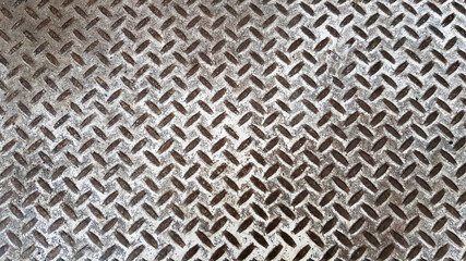 Metal background as a creative texture close up. Steel checkerboard made of sheet metal with...