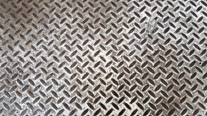 Metal background as a creative texture close up. Steel checkerboard made of sheet metal with factory floors, anti-slip platform for engineering materials. abstract pattern