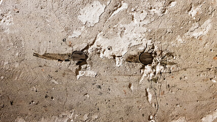 Reinforced concrete wall is useful as a background. Reinforced concrete with damaged metal fittings