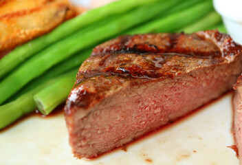 Closeup Medium Grilled Filet Mignon Steak Cut in Half Showing Mouthwatering Pink Brown Texture