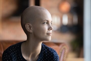 Optimistic young oncology patient looking away with hope, thinking of treatment recovery, remission...