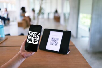 Qr code payment. Woman scanning QR code online shopping cashless technology concept.