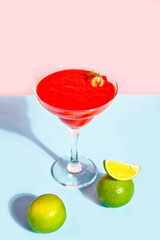 Cold strawberry margarita or daiquiri cocktail with lime and rum