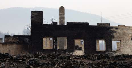 Fire Debris of Houses in a small town with smoke in sky. Caused by Forest Wildfires in Lytton,...