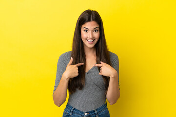 Young Brazilian woman isolated on yellow background with surprise facial expression