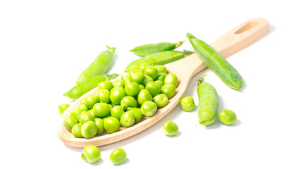 Ripe green peas in a wooden spoon on a white background