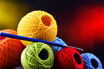 Assortment of different colored yarns and hook for crocheting