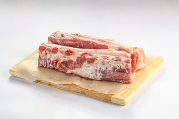 Raw pork ribs over board