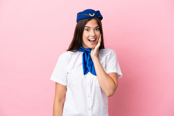 Airplane stewardess Brazilian woman isolated on pink background with surprise and shocked facial...
