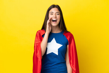 Super Hero Brazilian woman isolated on yellow background shouting with mouth wide open