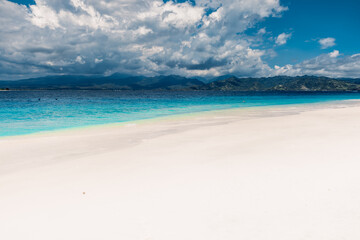 Tropical white sand beach and blue ocean in tropics