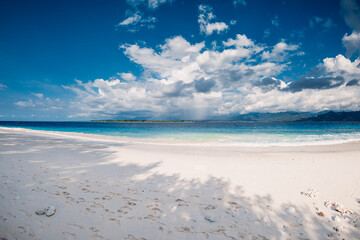 Tropical white sand beach and blue ocean in tropics