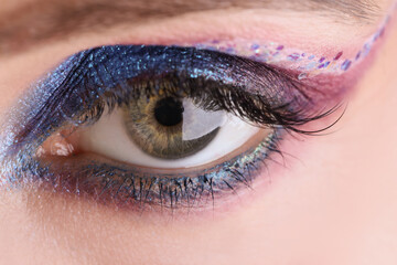 Fototapeta premium Blue eyeshadow applying makeup for eyes closeup