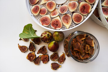 Fresh figs lie on the table next to dried figs. Top view