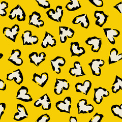 Leopard heart seamless pattern. Vector animal print. Black and white spots on yellow background. Jaguar, leopard, cheetah, panther fur. Leopard skin imitation can be painted on clothes or fabric.