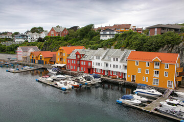 Traditional wooden buildings along the waterfront and the marina. Smedasundet area and river in the center of the town. Surrounded by traditional buildings and boats in the water, Haugesund, Norway.