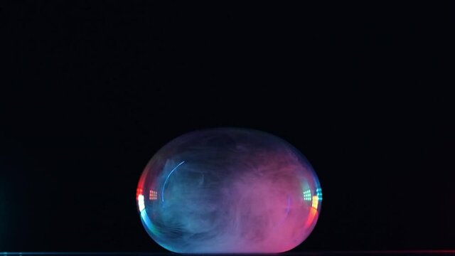 The explosion of soap bubble on a black background. slow motion