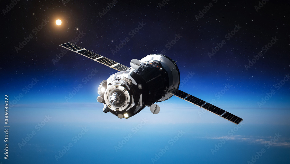 Canvas Prints spaceship on orbit of earth. blue planet and sun light. space craft in dark space. expedition to int