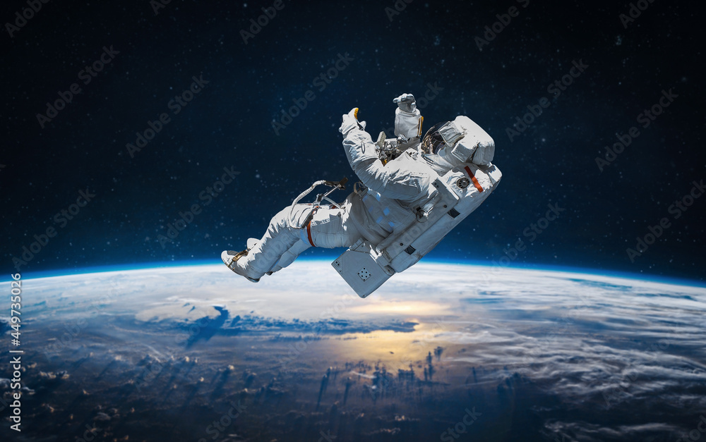 Fototapete astronaut on orbit of earth. planet earth. sky and clouds. stratosphere. view from iss. elements of 