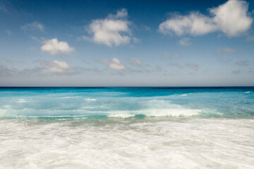 Fototapeta na wymiar Tropical sand beach and blue sky, hot summer day, waves on the beach, retro tones