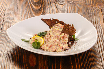Tartar with beef meat served lemon
