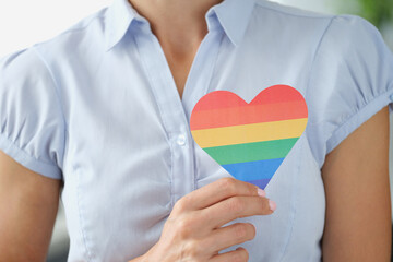 Woman holding multi colored lgbt heart closeup