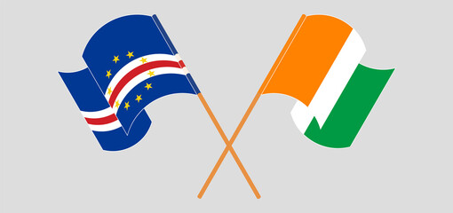Crossed and waving flags of Cape Verde and Republic of Ivory Coast