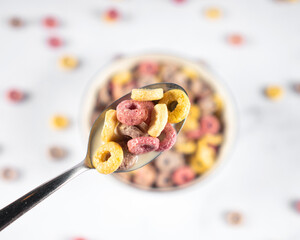 Coloful Cereal breakfast rings Loops in a Bowl with spoon