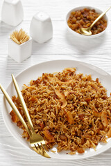 Coconut Rice with raisins on a plate, top view