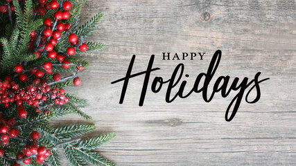 Happy Holidays Script Text with Holiday Evergreen Branches and Red Berries on Side Over Rustic Wood...