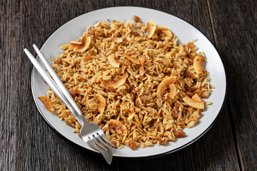 Coconut Rice with raisins on a plate, top view