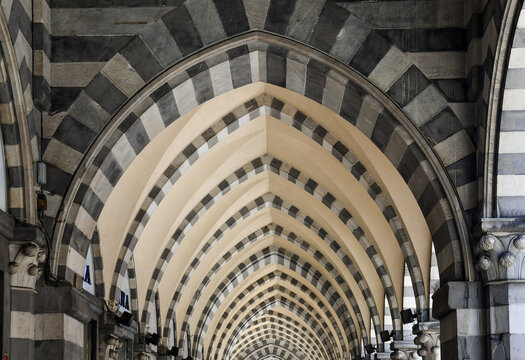 Fototapeta Detail of the arcade in Gothic style in Via XX Settembre, one of the main street of Genoa, with black and white marble bands, Liguria, Italy