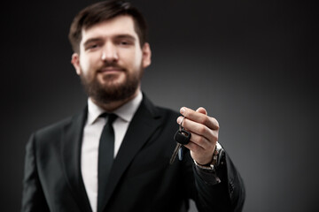 Succesful man in suit holding car keys in hand
