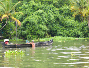 A fisherman doing his work in the morning in the Kerala river in India