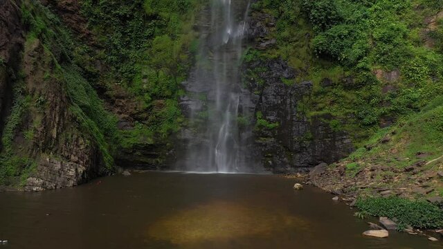 Aerial Wli Falls highest in Ghana Africa tilt up Waterfalls is the highest waterfall in Ghana and the tallest in West Africa. It has lower and an upper fall. Thousands of bat roost on the cliff near 