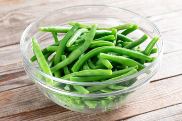 Green beans in glass bowl on a table