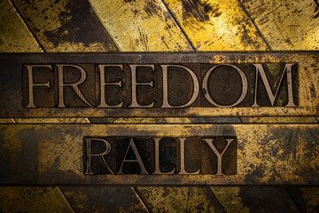 Freedom Rally text message on textured grunge copper and vintage gold background