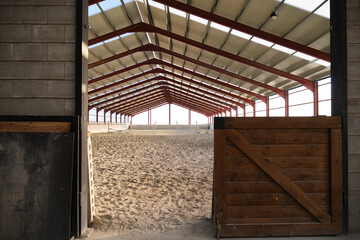 Entry to an empty horse riding hall.