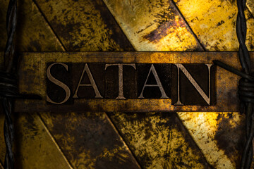 Satan text message on textured grungy bronze background