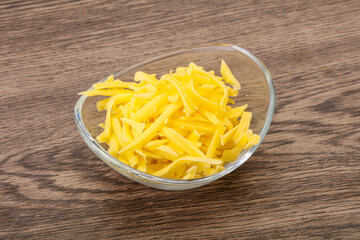 Shredded yellow cheese in the bowl